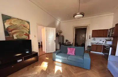 a living room with a blue couch and a tv at 1920s Charm apartment by Jerusalem Synagogue in Old Town Center in Prague