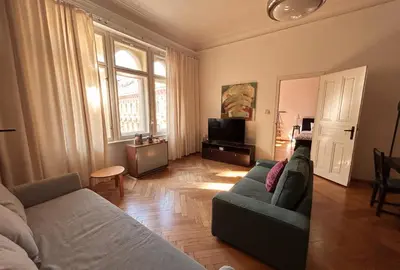 a living room with a couch and a tv at 1920s Charm apartment by Jerusalem Synagogue in Old Town Center in Prague