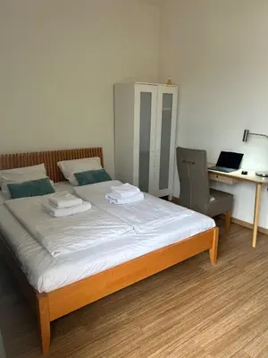 a bedroom with a bed and a desk and a chair at Affordable Top floor 2BR nightlife location in Center and yet Quite Sleep in Prague