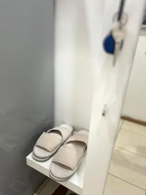 a row of sandals sitting on a shelf in a room at Affordable Top floor 2BR nightlife location in Center and yet Quite Sleep in Prague