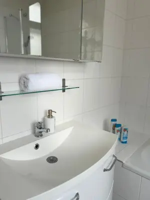 a white bathroom with a sink and a mirror at Affordable Top floor 2BR nightlife location in Center and yet Quite Sleep in Prague