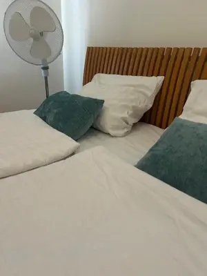 a bedroom with two beds with pillows and a fan at Affordable Top floor 2BR nightlife location in Center and yet Quite Sleep in Prague