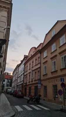 a street with buildings and a motorcycle parked on the street at 2 min Center Just In, Old Town Walk private room B in Prague