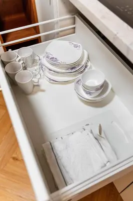 a drawer filled with plates and cups and dishes at LuxeLoftPrague in Prague