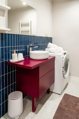 a bathroom with a sink and a washing machine at LuxeLoftPrague in Prague