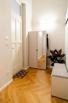 a hallway with a mirror and a door in a room at LuxeLoftPrague in Prague
