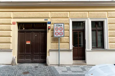 a sign in front of a building with two doors at LuxeLoftPrague in Prague