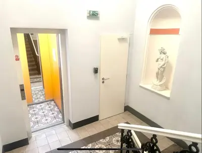 a room with a picture of a crown on the wall at Golden Dome Skyline Retreat Modern 2BR Apartment in Prague 1 Center with King Bed and Museum View in Prague
