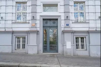 a large white building with trees in front of it at Golden Dome Skyline Retreat Modern 2BR Apartment in Prague 1 Center with King Bed and Museum View in Prague