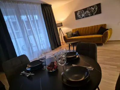 a living room with a couch and a large window at Smichov luxury apartment Residence Madeleine in Prague