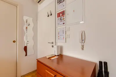 a room with a desk with a phone on the wall at Quaint Trendy Apartment in Prague