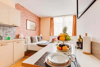a kitchen with a table with a bowl of fruit on it at Quaint Trendy Apartment in Prague