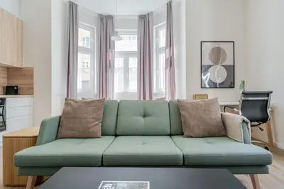 a bedroom with a large white bed and a window at Blueground Holešovice view nr Vltava PRG-52 in Prague