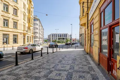 an empty city street with parked cars and buildings at Blueground Holešovice view nr Vltava PRG-52 in Prague
