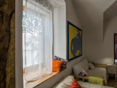 a living room with a couch and a window at Very old house Ptice in Ptice