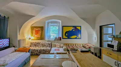 a living room with a couch and a table at Very old house Ptice in Ptice
