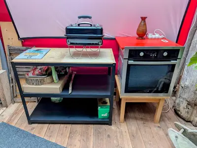 a stove and a table in a tent at Very old house Ptice in Ptice