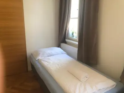 a small bed in a room with a window at Prague apartment in Centre city in Prague