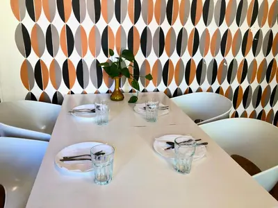 a white table with plates and glasses and a wall at Prague apartment in Centre city in Prague