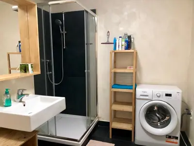a bathroom with a shower sink and a washing machine at Prague apartment in Centre city in Prague