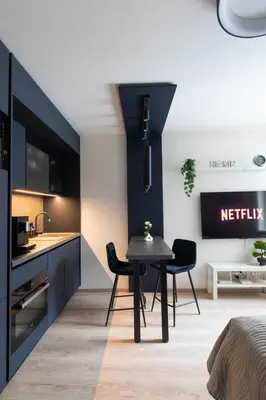 a kitchen with a table and chairs in a room at Smarty Choice Living with Netflix - Kubanske namesti in Prague