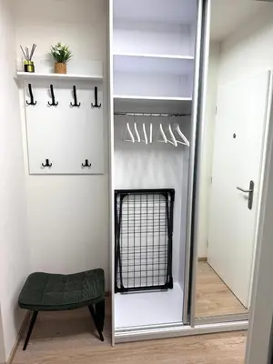 a dressing room with a mirror and a stool at Smarty Choice Living with Netflix - Kubanske namesti in Prague