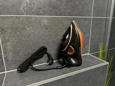 a black phone is sitting on a counter at Smarty Choice Living with Netflix - Kubanske namesti in Prague