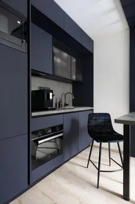 a black kitchen with a black chair and a sink at Smarty Choice Living with Netflix - Kubanske namesti in Prague