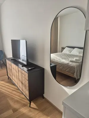 a bedroom with a large bed with two lamps at Holesovice Luxury Apartments in Prague