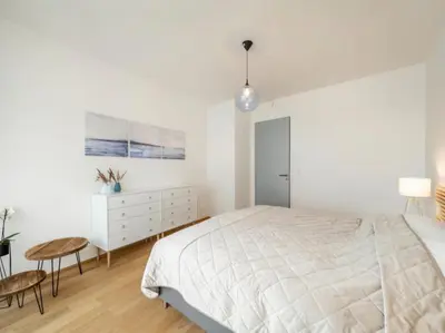 a bedroom with a bed and a table and a bed and a tv at Holesovice Luxury Apartments in Prague