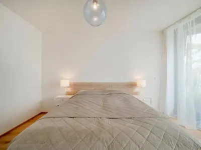 a white dresser in a room with a painting on the wall at Holesovice Luxury Apartments in Prague