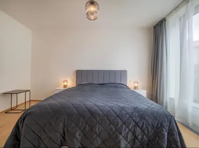 a bedroom with a large bed and a window at Holesovice Luxury Apartments in Prague