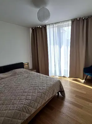 a living room with a couch and a lamp at Holesovice Luxury Apartments in Prague