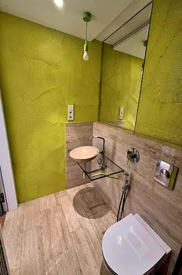 a kitchen with white cabinets and a wooden table at Holesovice Luxury Apartments in Prague