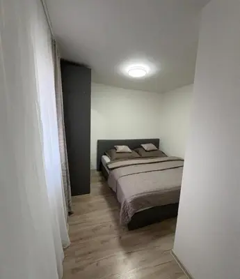 a bedroom with a bed in a white room at Countryside Apartments 252 in Poříčí nad Sázavou