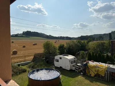 a white trailer parked in a field with a field of hay at Countryside Apartments 252 in Poříčí nad Sázavou