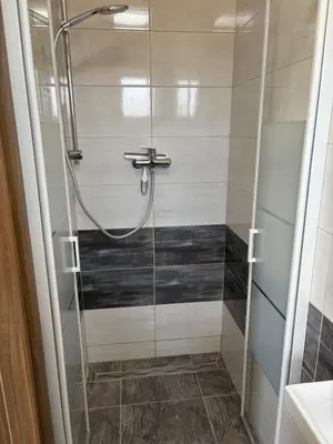 a shower with a glass door in a bathroom at Countryside Apartments 252 in Poříčí nad Sázavou
