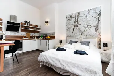 a white bedroom with a desk and a bed at Bohemian Emperors Residence in Prague