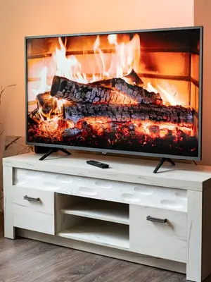 a television on a white entertainment center with a fireplace at Bohemian Emperors Residence in Prague