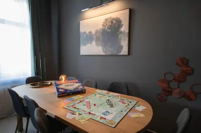 a dining room table with a board game on it at Spacious Apartment Xbox, Cinema & Foosball in Prague in Prague