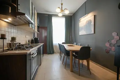 a kitchen and dining room with a table and chairs at Spacious Apartment Xbox, Cinema & Foosball in Prague in Prague