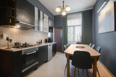 a kitchen with a table and a dining room at Spacious Apartment Xbox, Cinema & Foosball in Prague in Prague