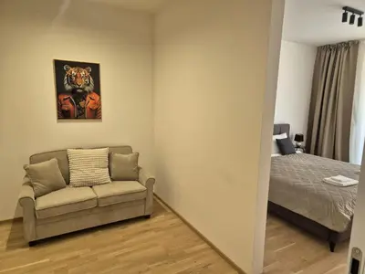 a living room with a couch and a bed at Smichov Luxury Apartments Residence Madeleine in Prague