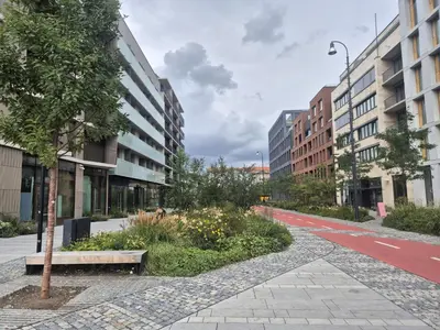 an empty street in a city with tall buildings at Smichov Luxury Apartments Residence Madeleine in Prague