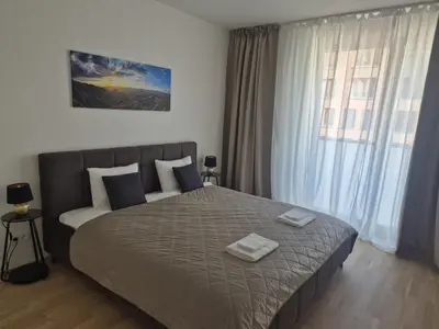 a bedroom with a large bed with two towels on it at Smichov Luxury Apartments Residence Madeleine in Prague