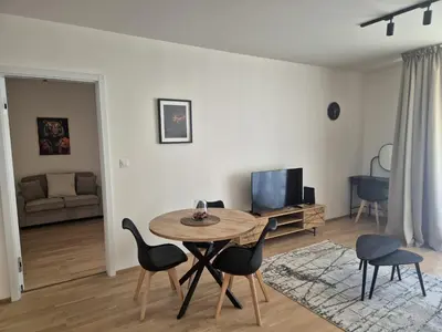 a living room with a table and chairs at Smichov Luxury Apartments Residence Madeleine in Prague