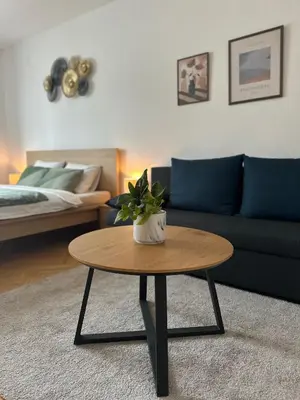 a living room with a couch and a coffee table at Spacious residential apt with balcony by TV tower in Prague