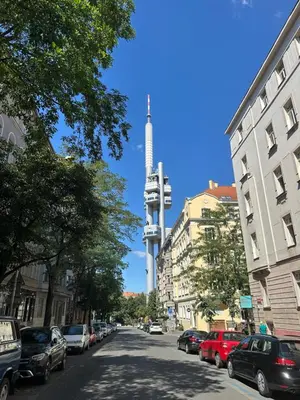 a city street with a clock tower in the background at Spacious residential apt with balcony by TV tower in Prague