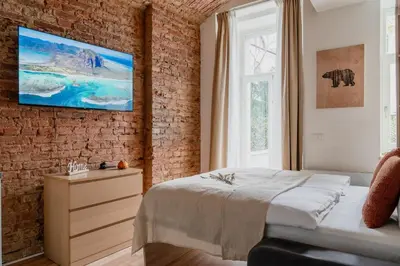 a bedroom with a bed and a brick wall at Apartment Dalimilova in Prague