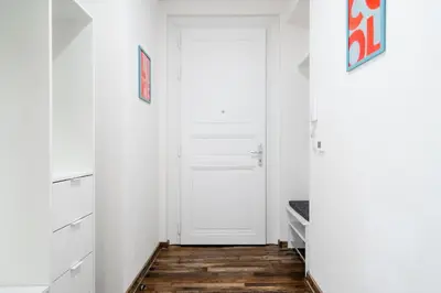 a hallway with a white door and wooden floors at Apartment Dalimilova in Prague